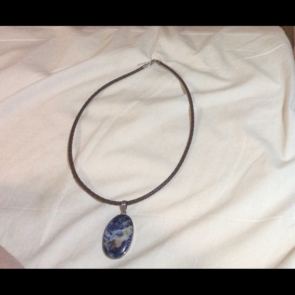 Sodalite piece strung on braided leather cord.